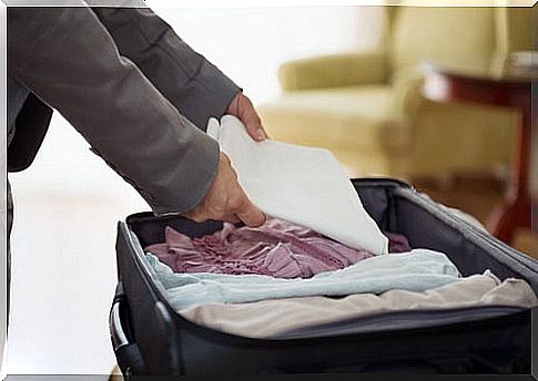 Woman packing suitcase