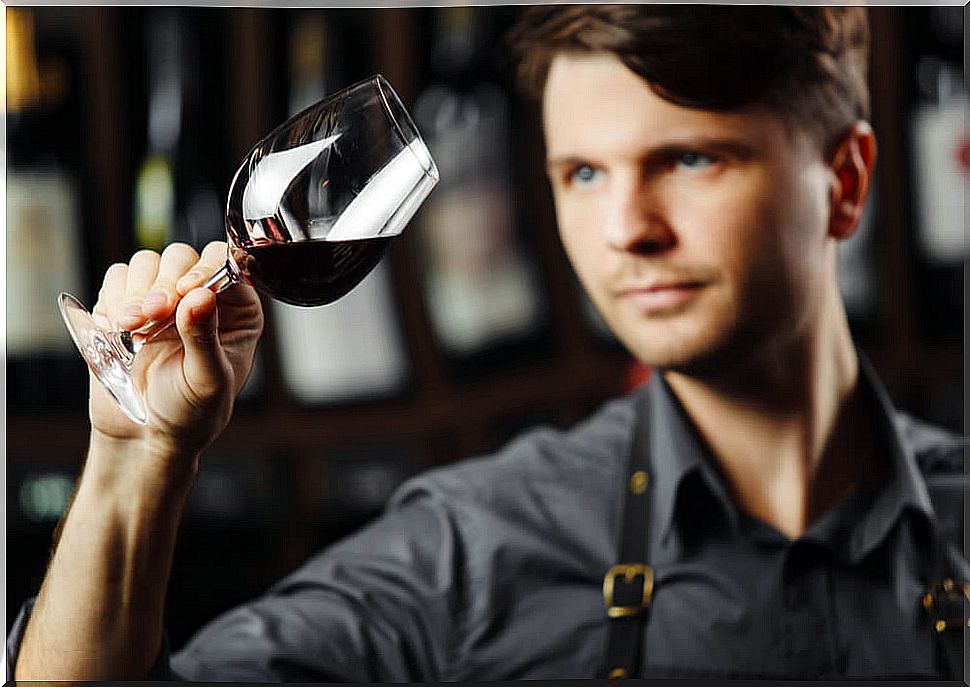 Man looking at a glass of wine