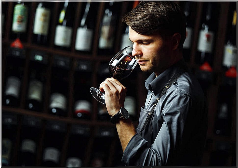 Man smelling a glass of wine