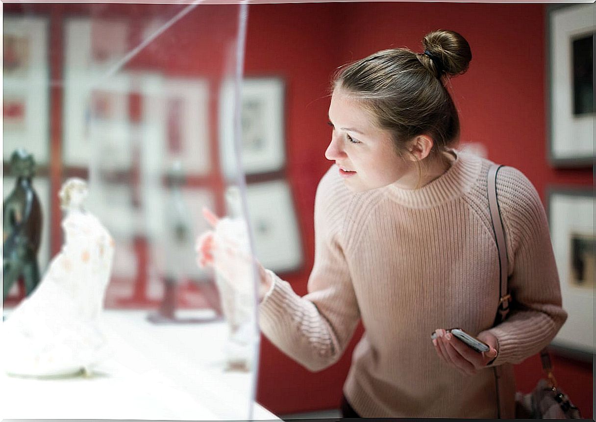 Woman viewing artwork in a museum.