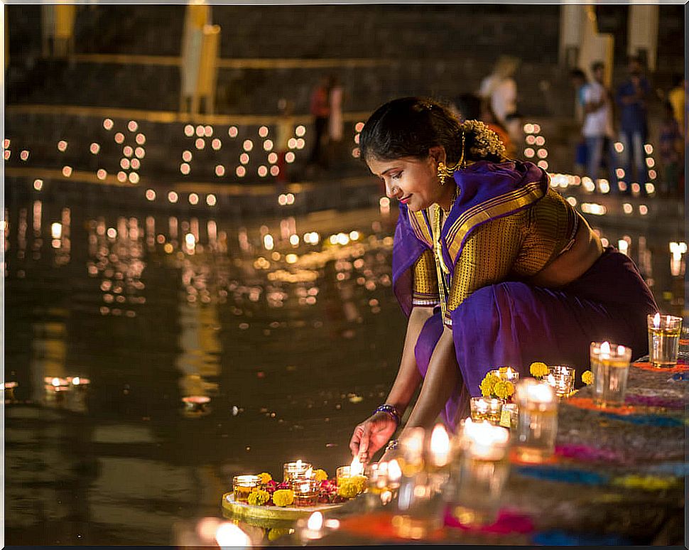 Woman lighting a lantern on Diwali